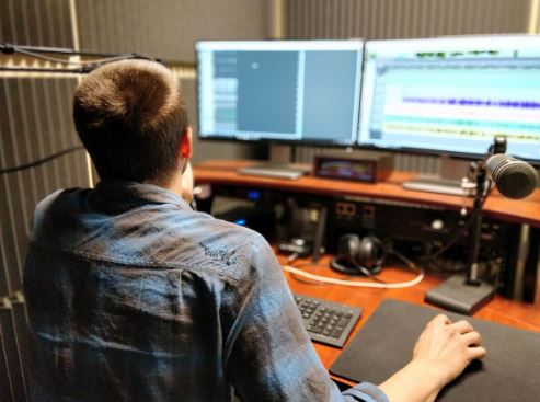 Help Desk Specialist, Matt Demas, editing a technology video in the audio suite